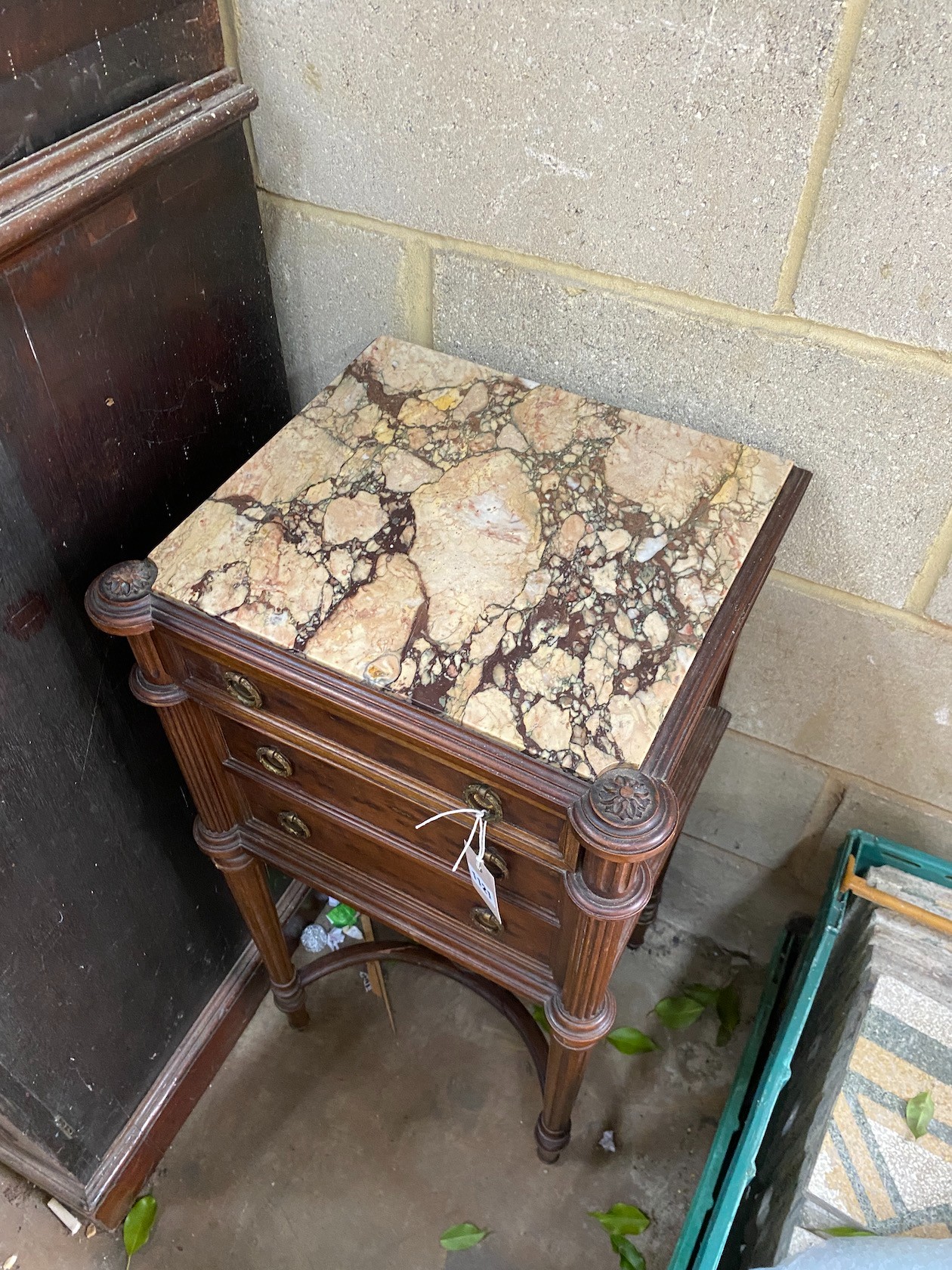 An early 20th century French marble topped mahogany bedside cabinet, fitted with a single drawer above a pot cupboard disguised as two drawers, 84 cm high, 42 cm wide 37 cm deep